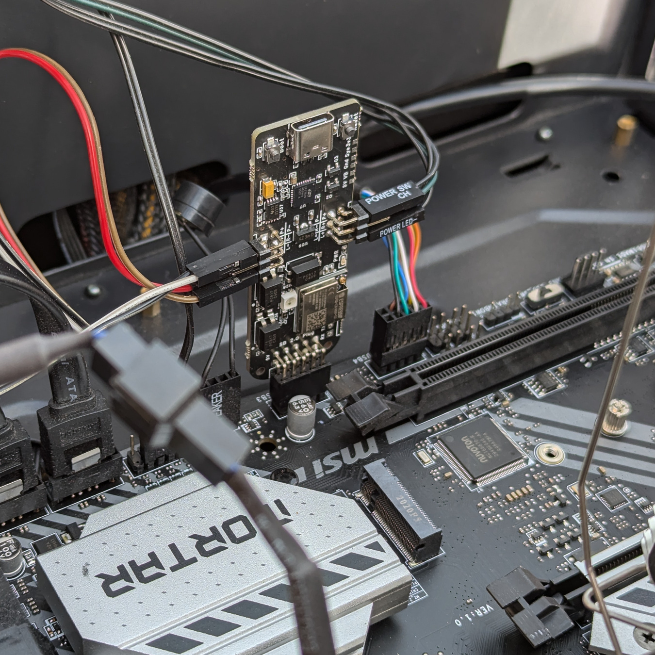 PokyPow hardware installed inside a desktop computer case connected to motherboard and case